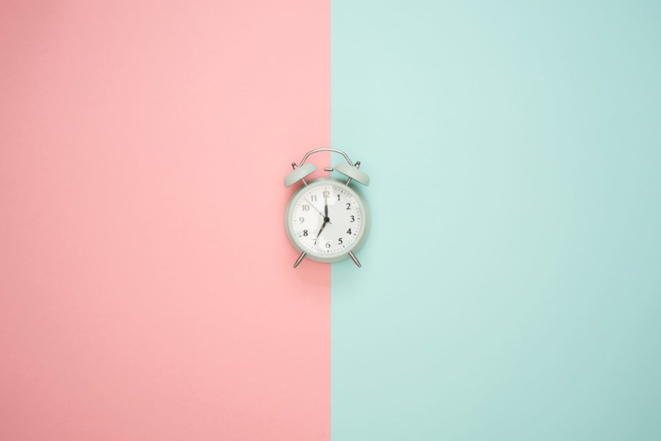 Blue and Pink background behind white clock